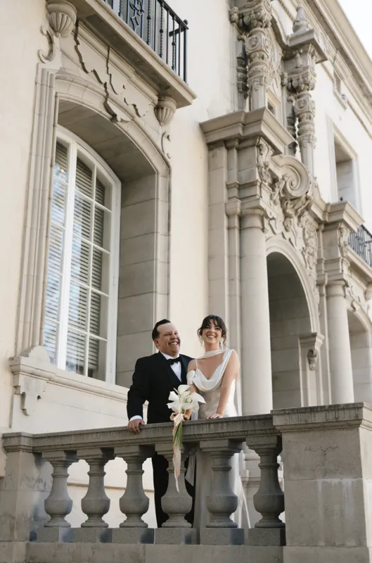 Elegant wedding couple portrait at historic estate balcony